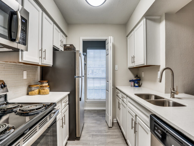 Kitchen with stainless steel appliances and access to laundry