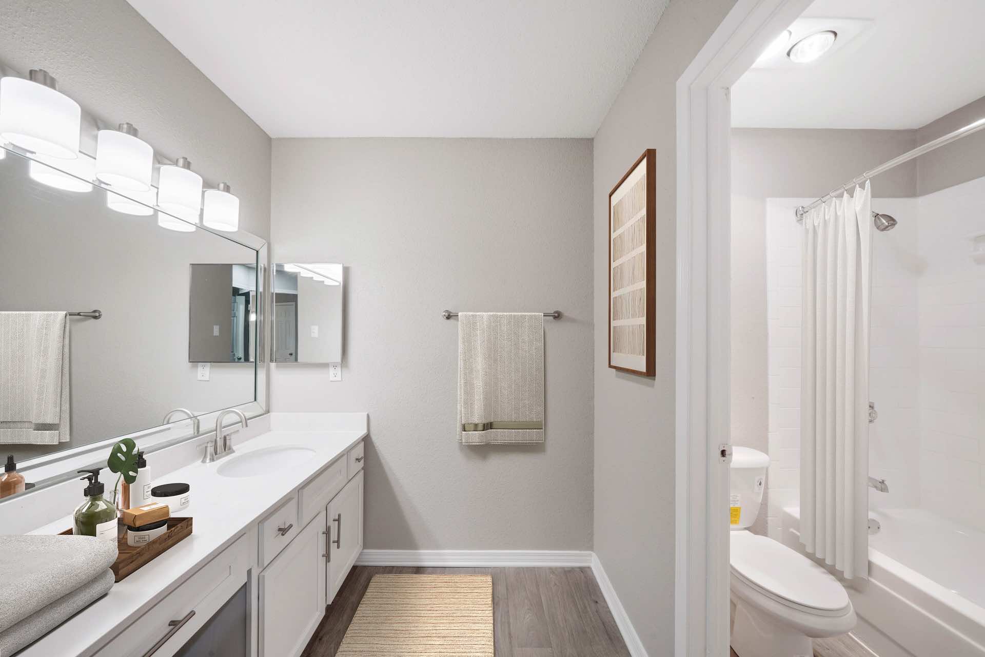 spacious bathroom with large mirror