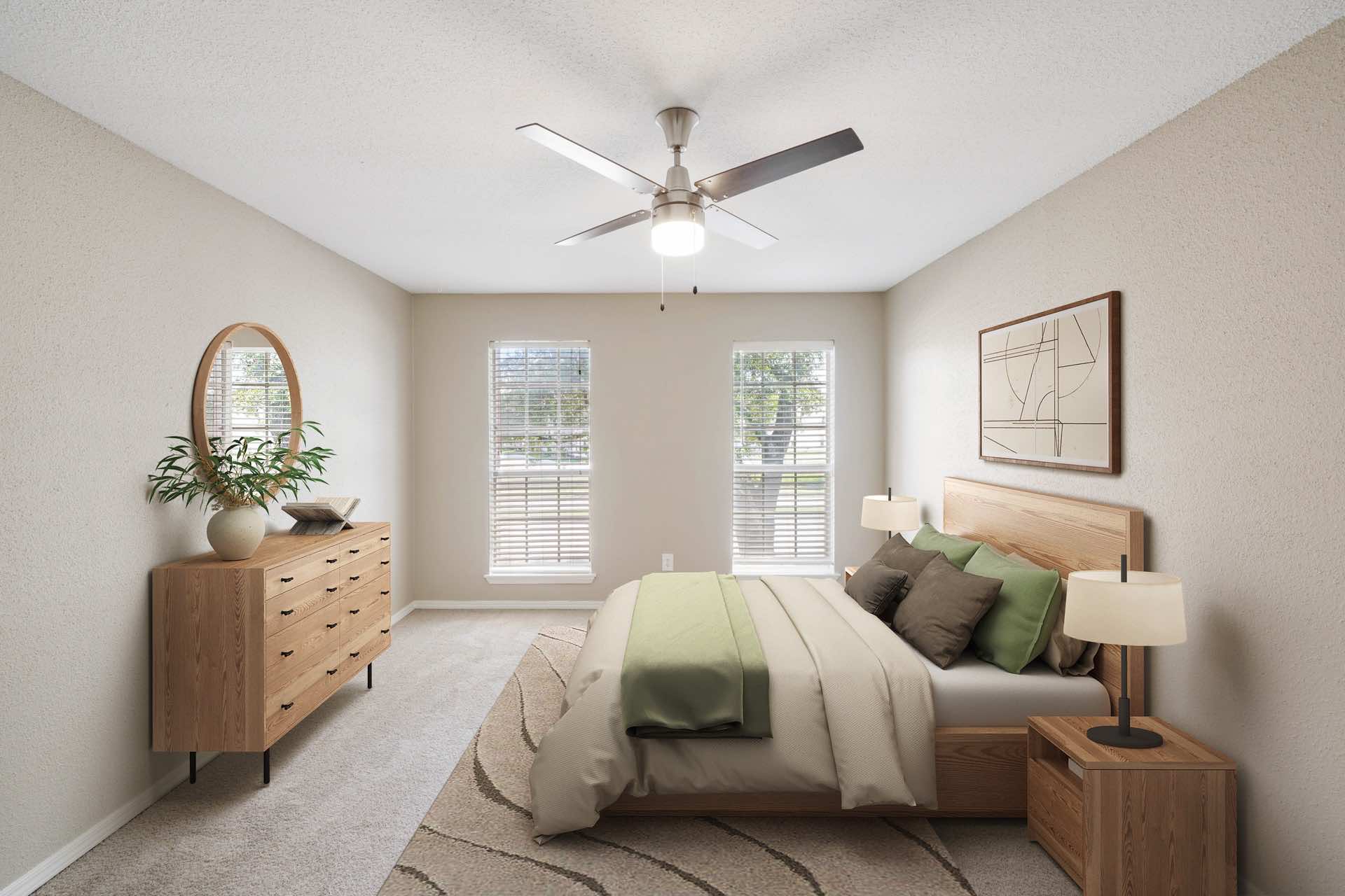 bedroom with ceiling fan and two windows