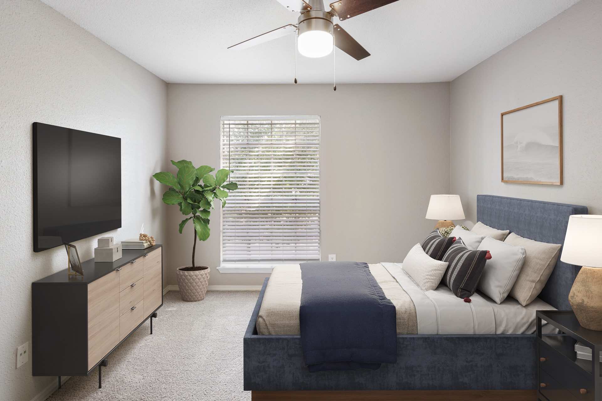 ceiling fan, wall-mounted tv, and large window in bedroom