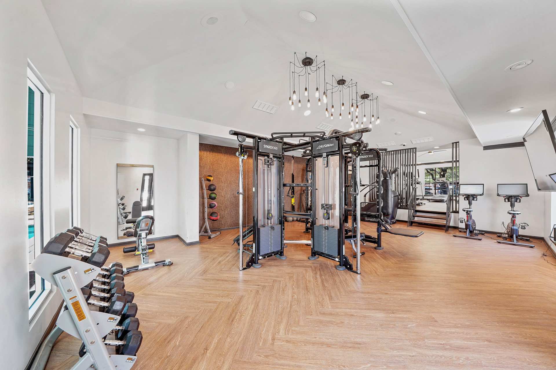 high ceiling and wood-style flooring in fitness center