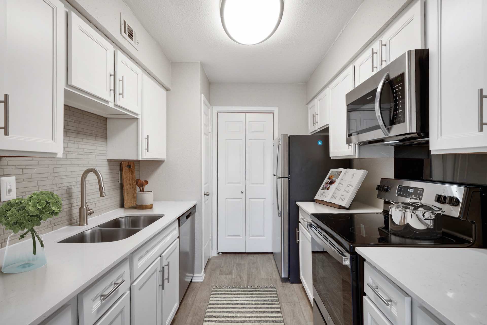 apartment kitchen with vinyl wood plank flooring