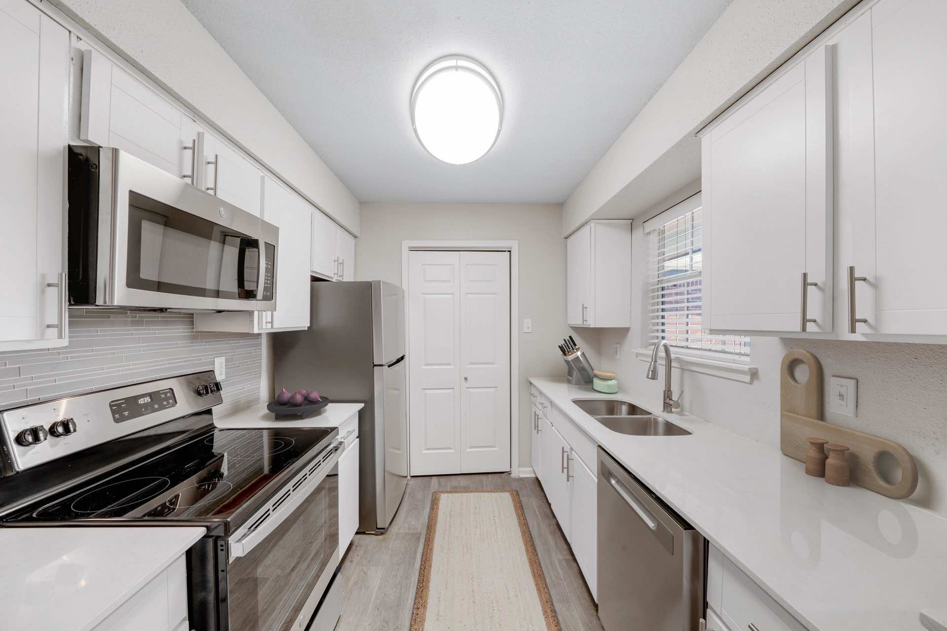 kitchen with wood style flooring and ample lighting